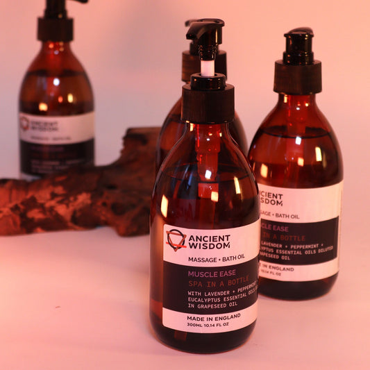 The Bliss Co Muscle Ease aromatherapy massage and bath oil in a 300ml bottle with pump, designed for relaxing massage and bathing.