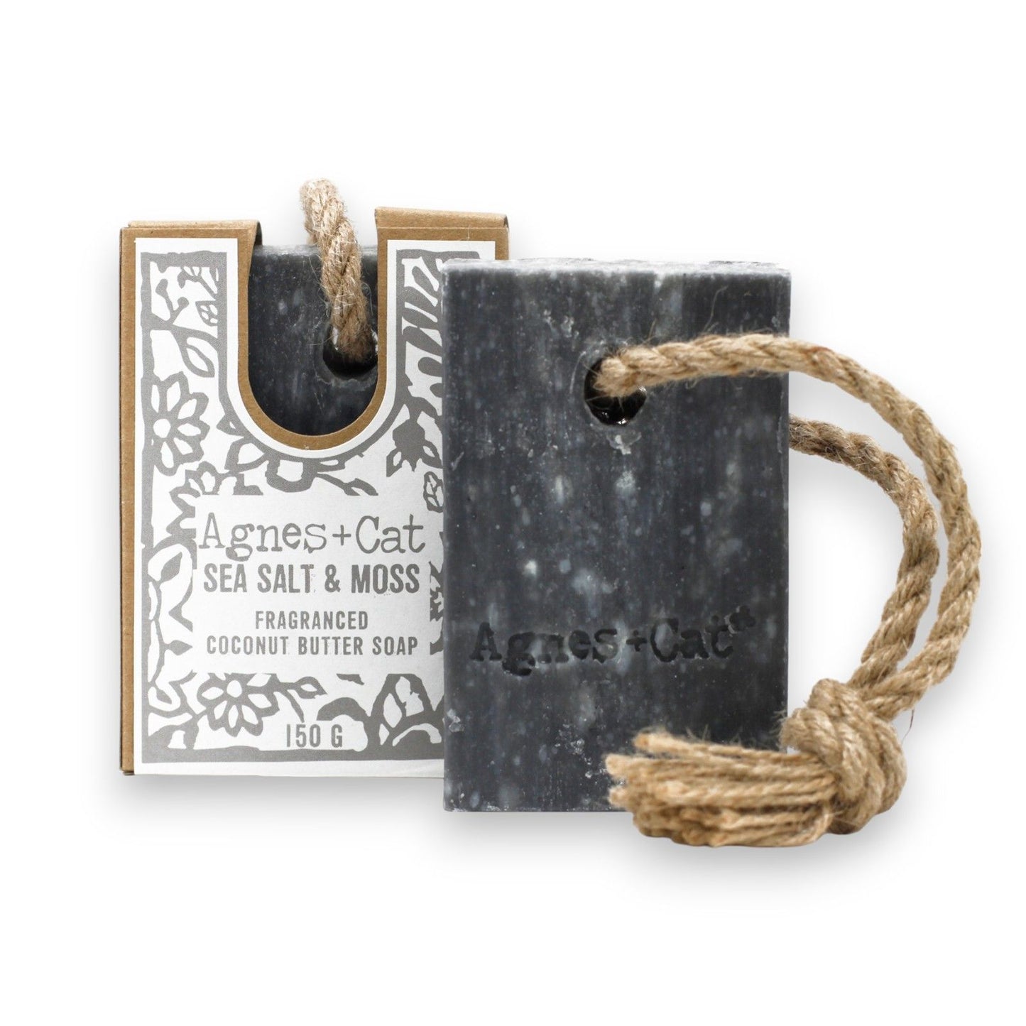 Agnes + Cat Soap on a Rope by The Bliss Co with sea salt and moss scent, hanging with natural fibers and textured surface.