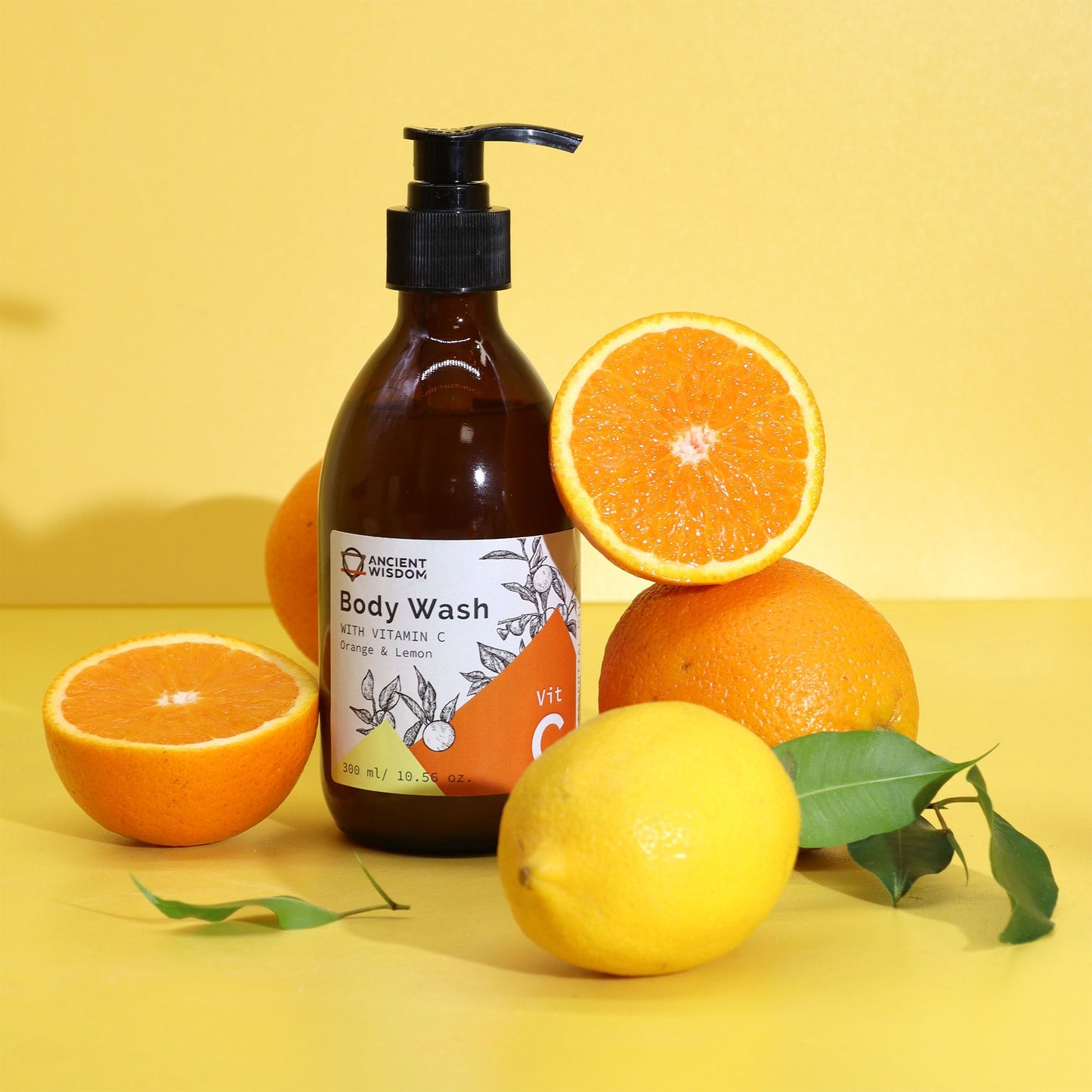 The Bliss Co Aromatherapy Body Wash with Vitamin C in orange and lemon scent, featuring a clear bottle with citrus-colored liquid.