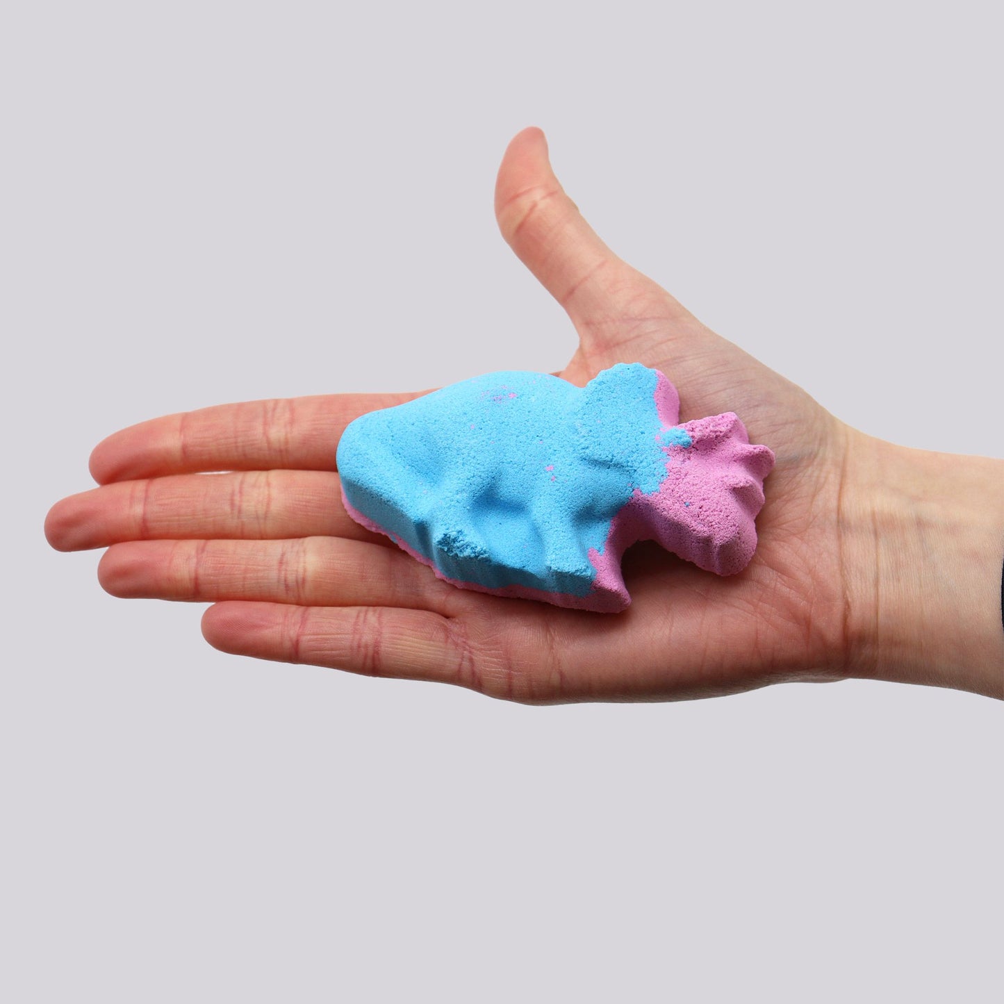 Colorful Dinosaur-shaped bath bomb for kids by The Bliss Co, showing vibrant design and fun dinosaur shape in the image.