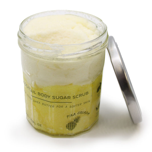The Bliss Co fragranced sugar body scrub in Pinacolada scent, 300g, with textured sugar and coconut fragrance visible in the image.