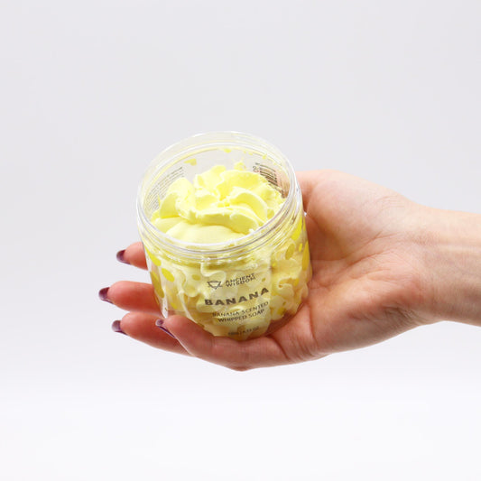 Banana whipped soap by AW Dropship UK in a 120g container, creamy and smooth in appearance, ideal for gentle cleansing.