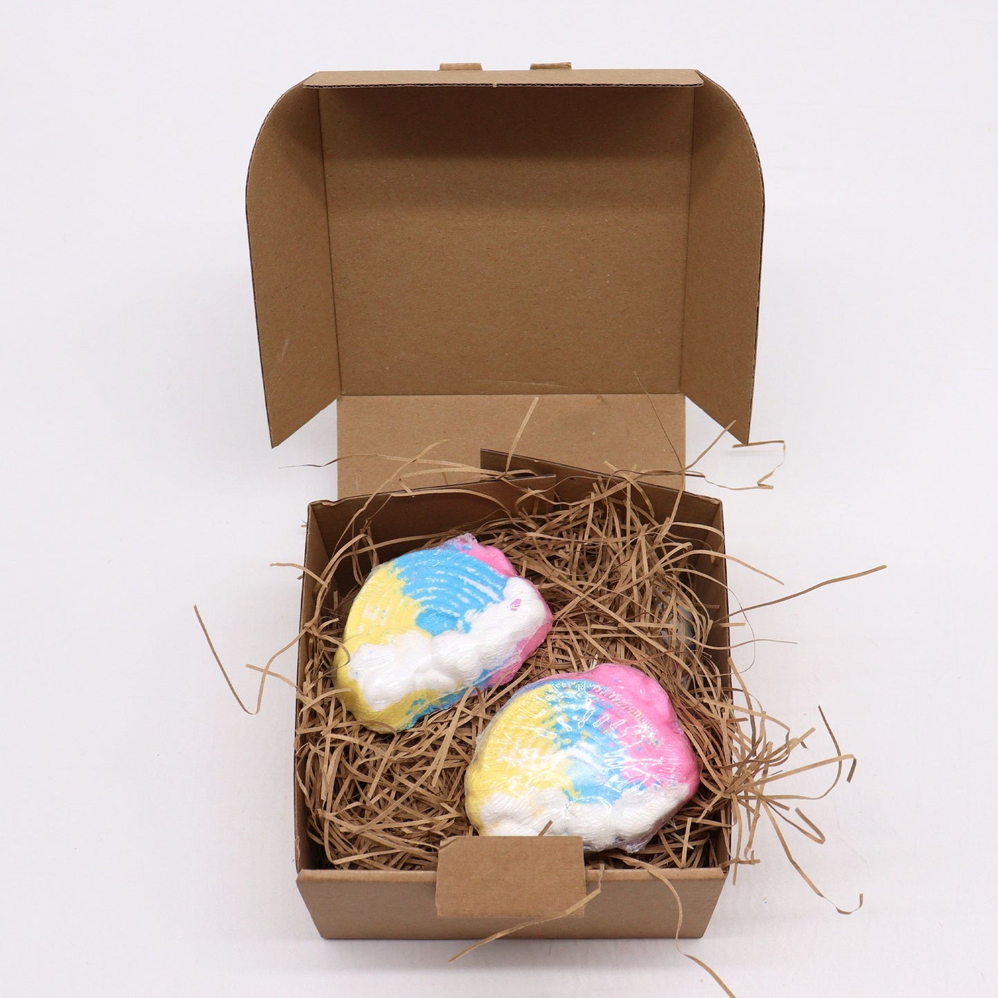 Colorful Cloud-shaped bath bomb for kids by The Bliss Co, 95g, with vibrant swirling colors and playful design.
