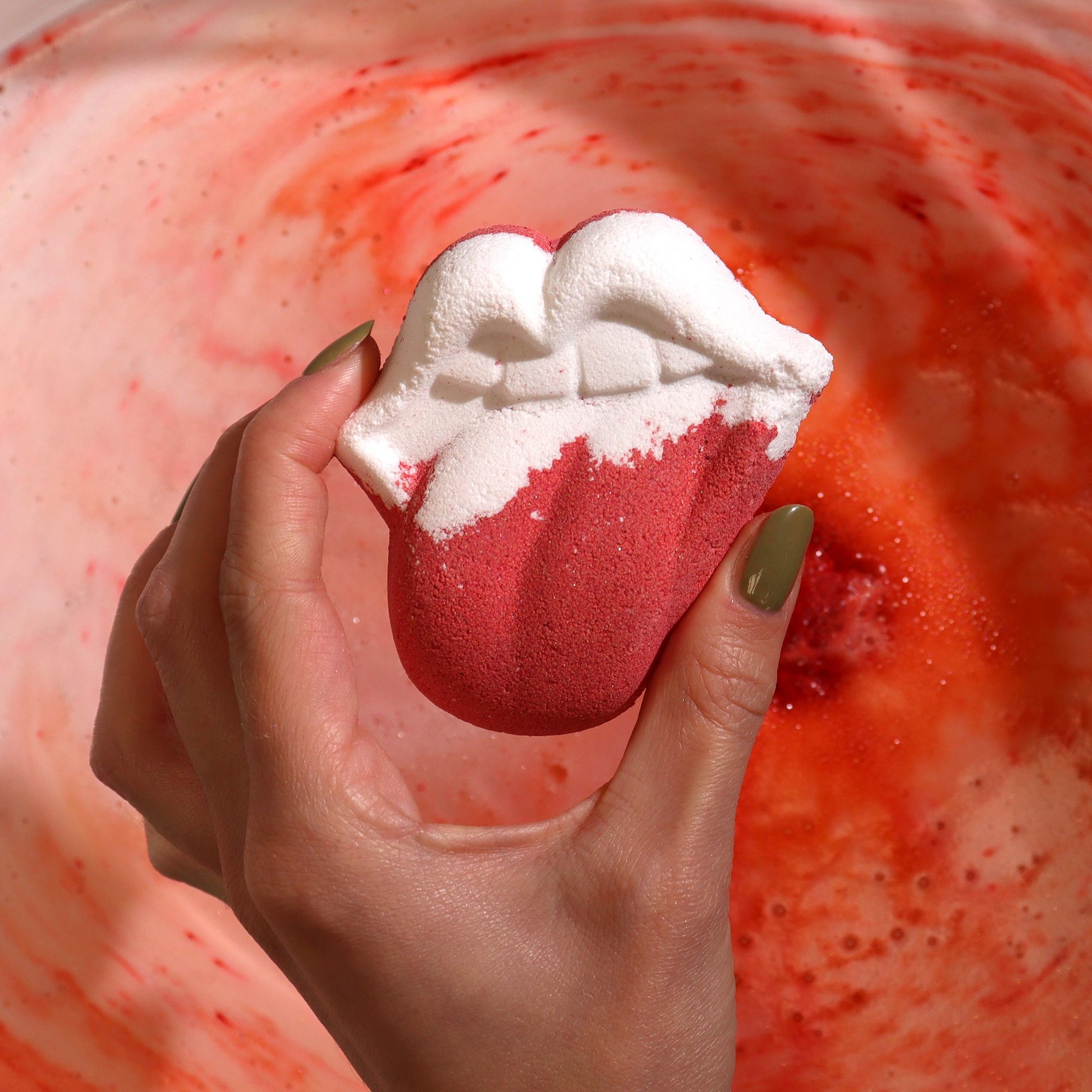 Colorful Lips-shaped bath bomb for kids by The Bliss Co, 60g, perfect for fun bath time relaxation and playful water coloring.