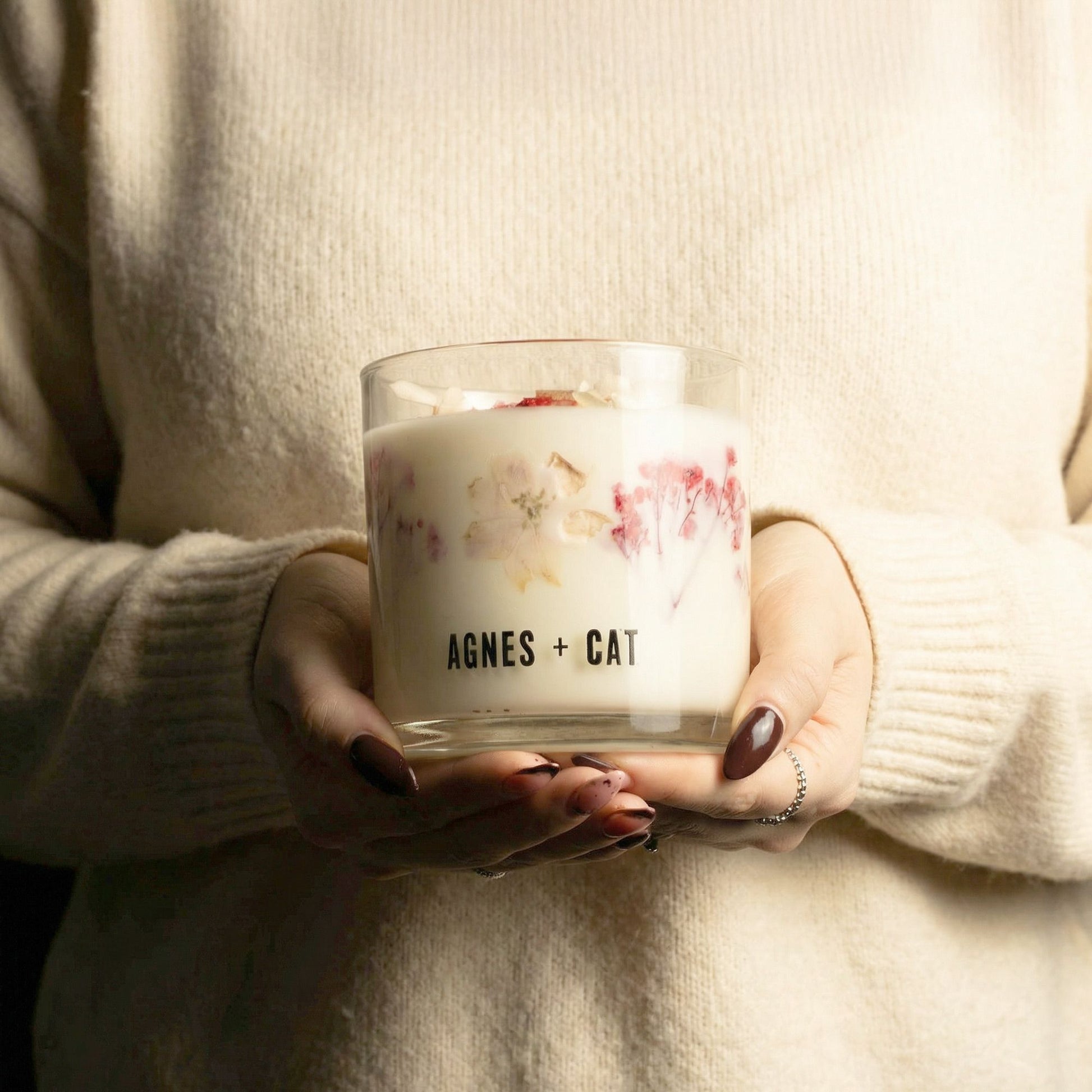 Agnes + Cat Botanical Soy Wax Candle by The Bliss Co with Fellberry scent, showing a stylish candle in a glass jar with botanical accents.