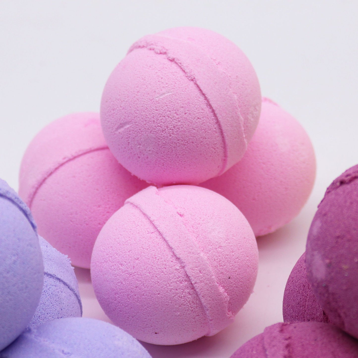 Essential Oil Bath Bomb by The Bliss Co with frankincense and rose, showing a colorful bath bomb with floral and aromatic details.