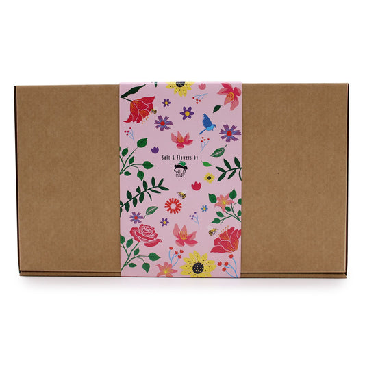 Wild Hare Salt & Flowers Set by The Bliss Co featuring a passion-scented salt soak with dried flowers in a glass jar.