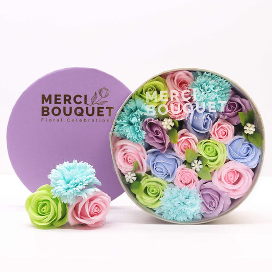Round Baby Blessings Soap Flower Gift Box by The Bliss Co featuring blue soap flowers in a decorative round box.