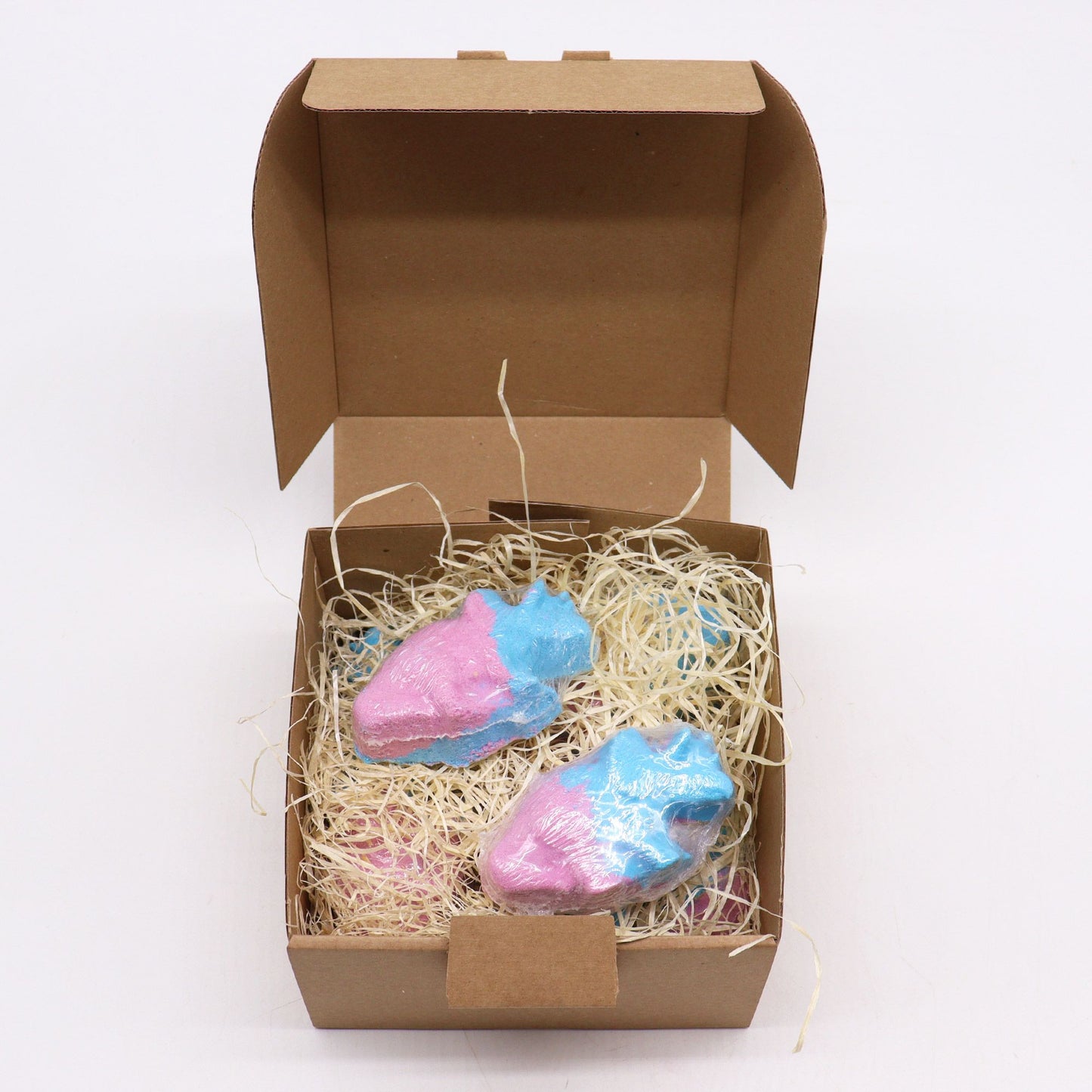 Colorful dinosaur-shaped bath bomb for kids, 80g by The Bliss Co, showcasing vibrant colors and fun design in the bath.