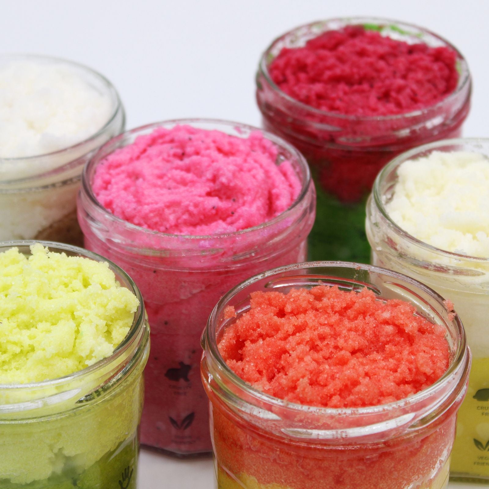 The Bliss Co strawberry rum fragranced sugar body scrub in a 300g jar with pink and red packaging.