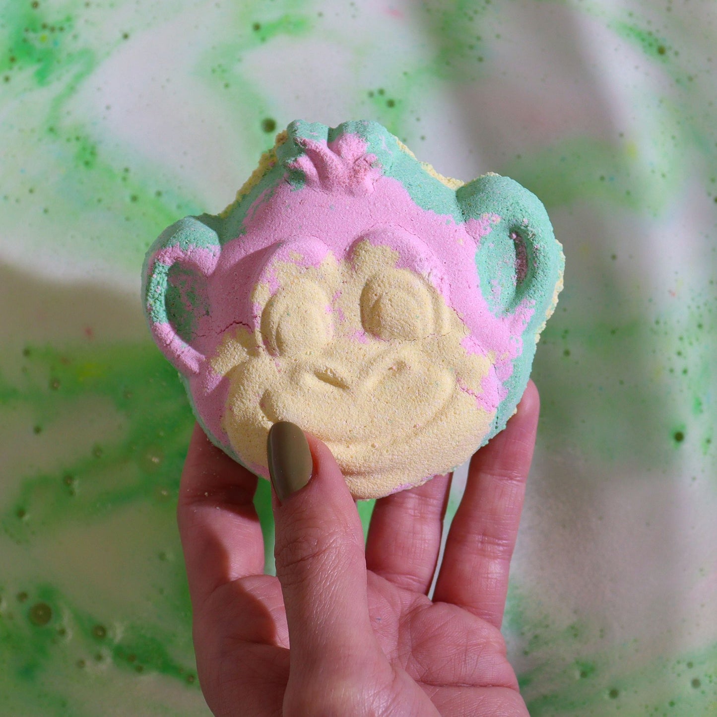 Colorful shaped Monkey bath bomb for kids by The Bliss Co, 90g, showing vibrant, playful design in a bathroom setting.