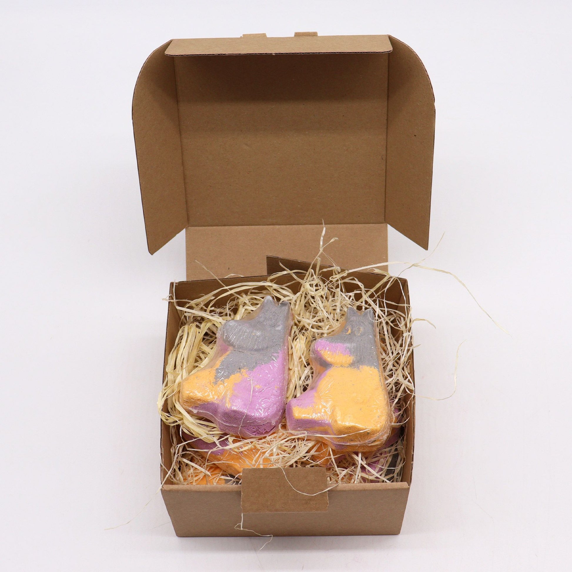 Colorful Hippo shaped bath bomb for kids by The Bliss Co, 85g, floating in water with vibrant bubbles.