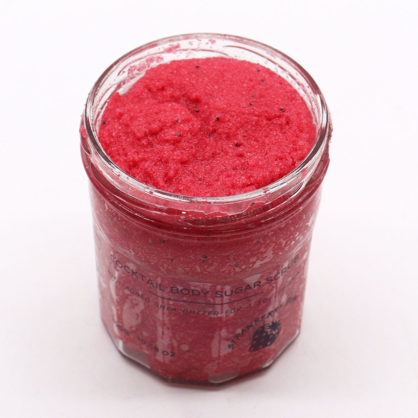 The Bliss Co strawberry rum fragranced sugar body scrub in a 300g jar showing textured sugar scrub with strawberry and rum scent.