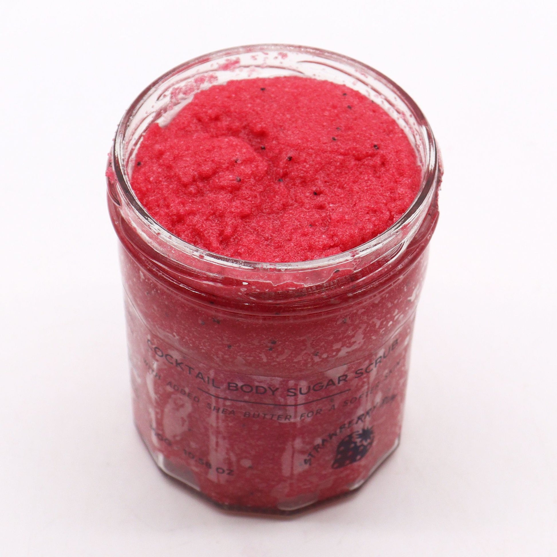 The Bliss Co strawberry rum fragranced sugar body scrub in a 300g jar showing textured sugar scrub with strawberry and rum scent.