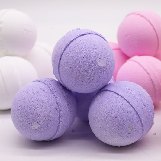 Essential Oil Bath Bomb by The Bliss Co with clary sage and juniper, featuring a colorful, round bath bomb with herbal accents.