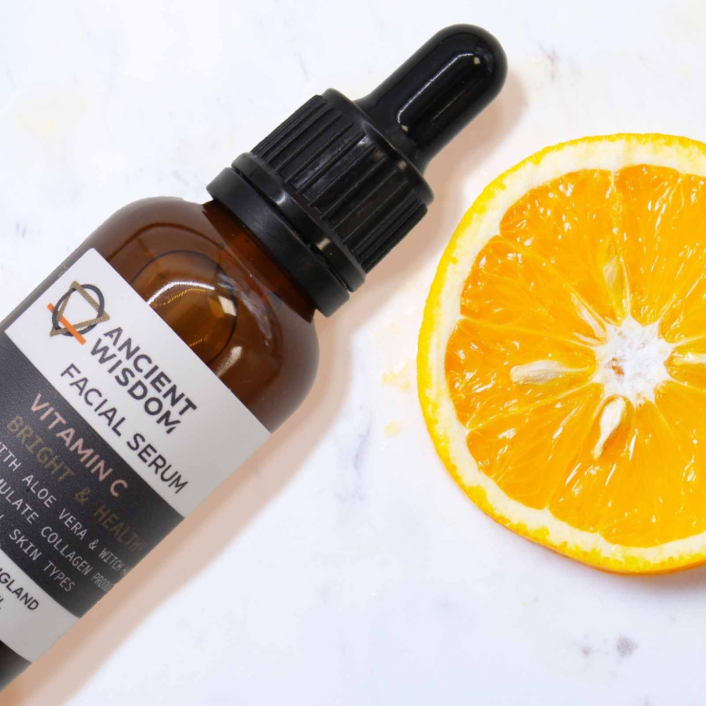 The Bliss Co Vitamin C Face Serum in a clear glass bottle with dropper, displayed against a light background.
