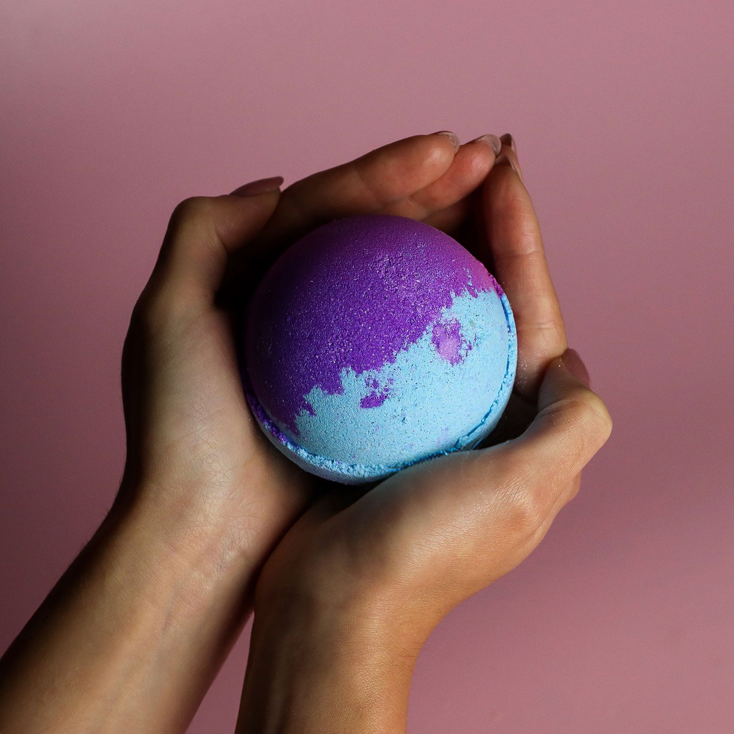 Jumbo Amethyst Creed bath bomb by The Bliss Co, 180g, showing a colorful, round bath bomb with purple and blue hues.