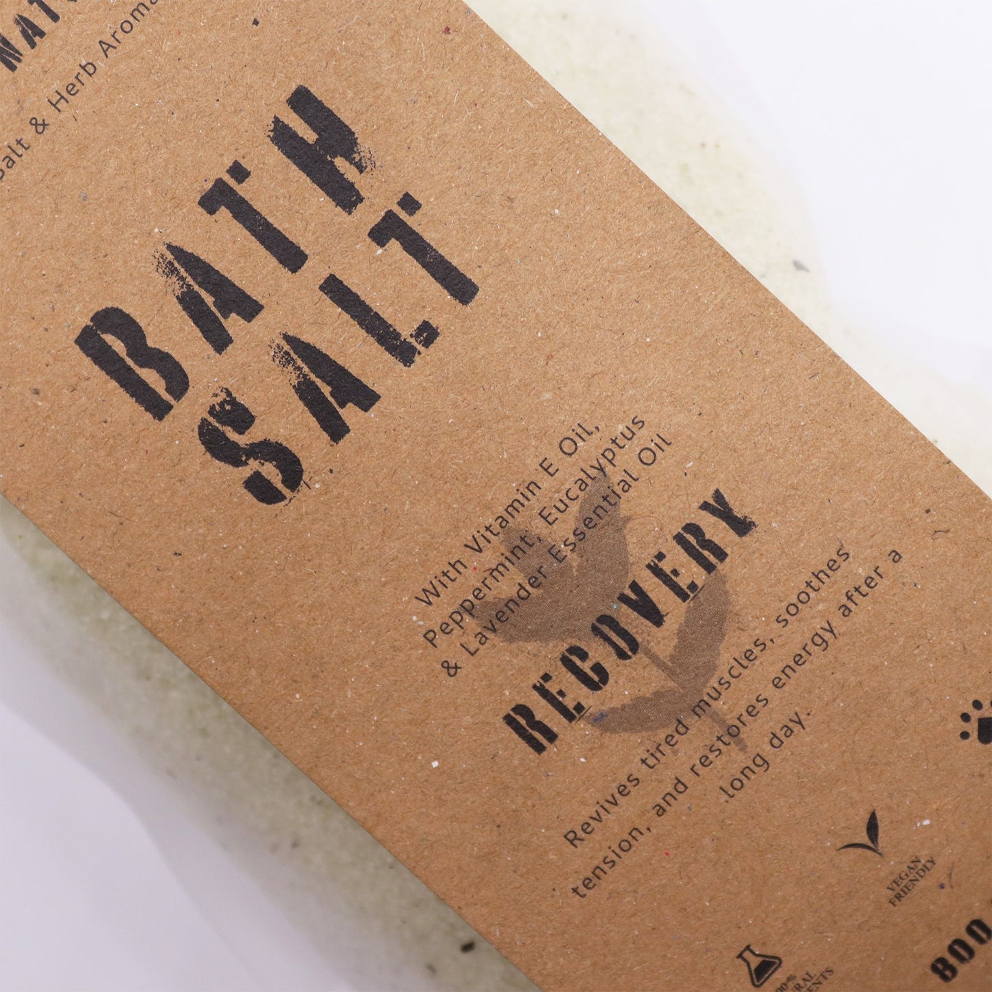 Greenman Rituals Menthol Aromatherapy Epsom Bath Salts by The Bliss Co for recovery, shown in a clear container with green and white salts.