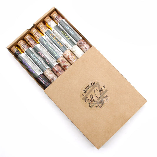 Set of seven The Bliss Co bath salts in small glass vials, perfect for gifting or relaxing bath experiences.