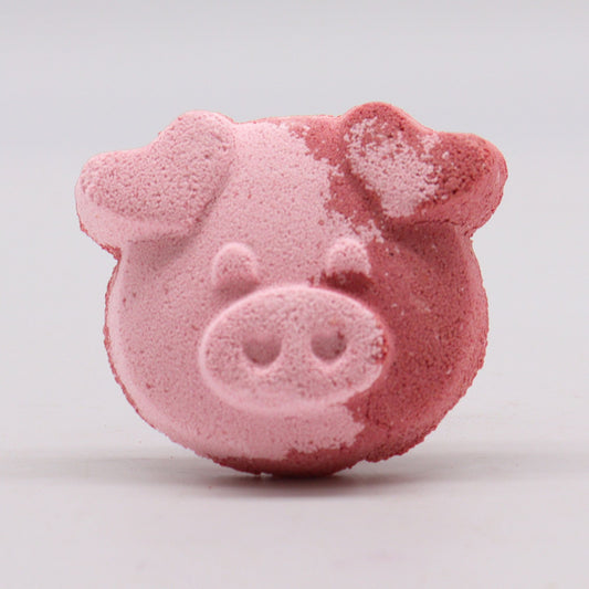 Colorful pig-shaped bath bomb for kids, 70g by The Bliss Co, designed for a fun and relaxing bath experience.