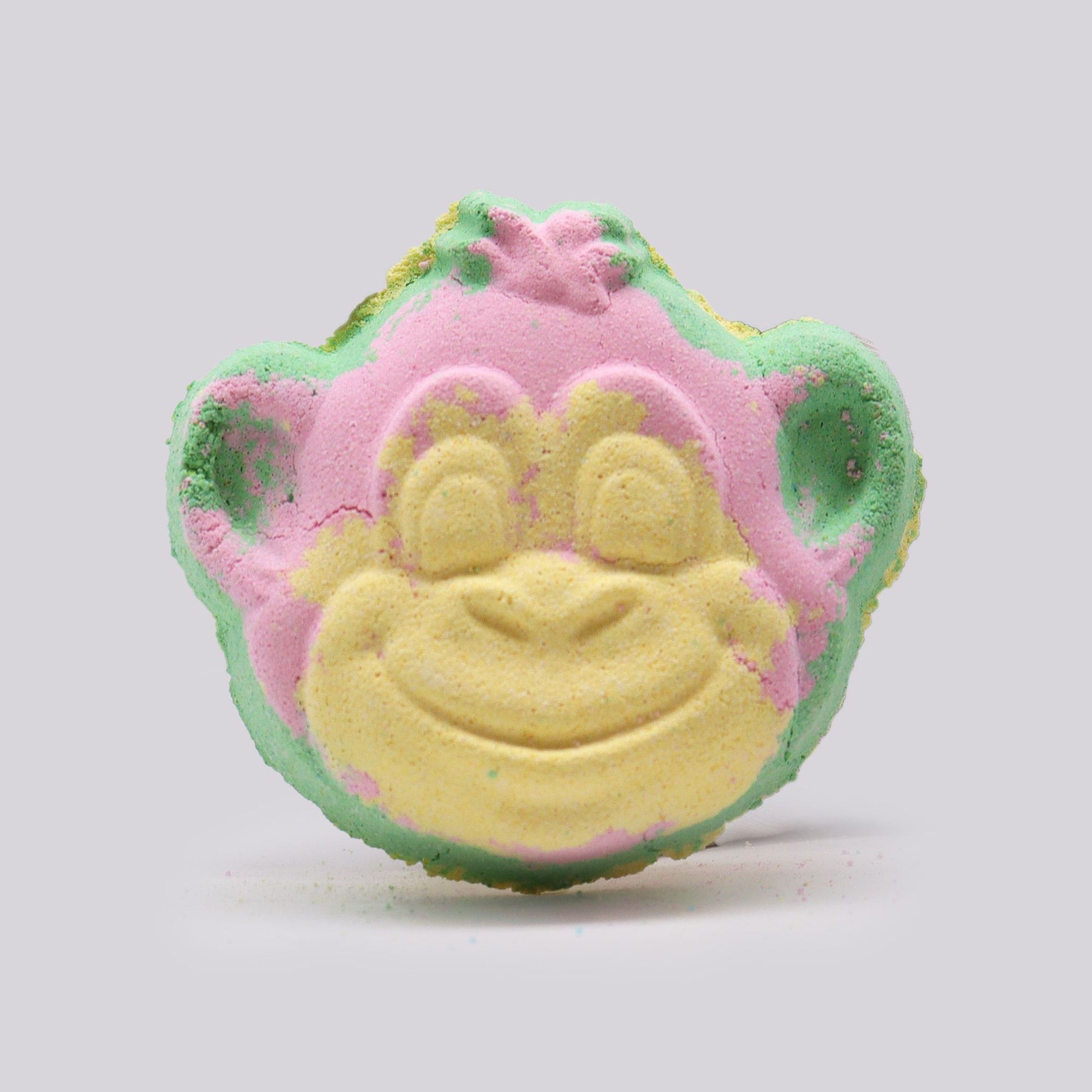 Colorful monkey-shaped bath bomb for kids by The Bliss Co, 90g, with vibrant swirling colors and playful design.