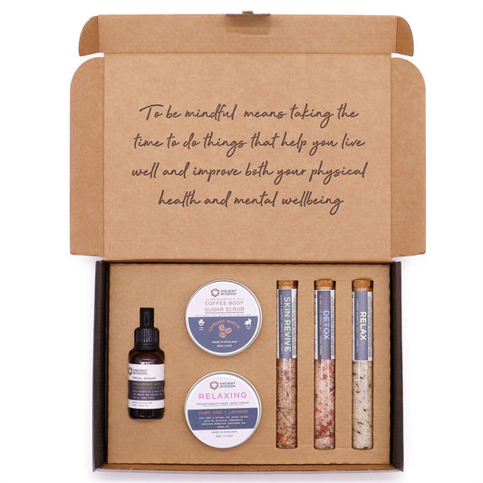 Self-care kit by The Bliss Co featuring calming candles, essential oils, and wellness items for mindful relaxation.